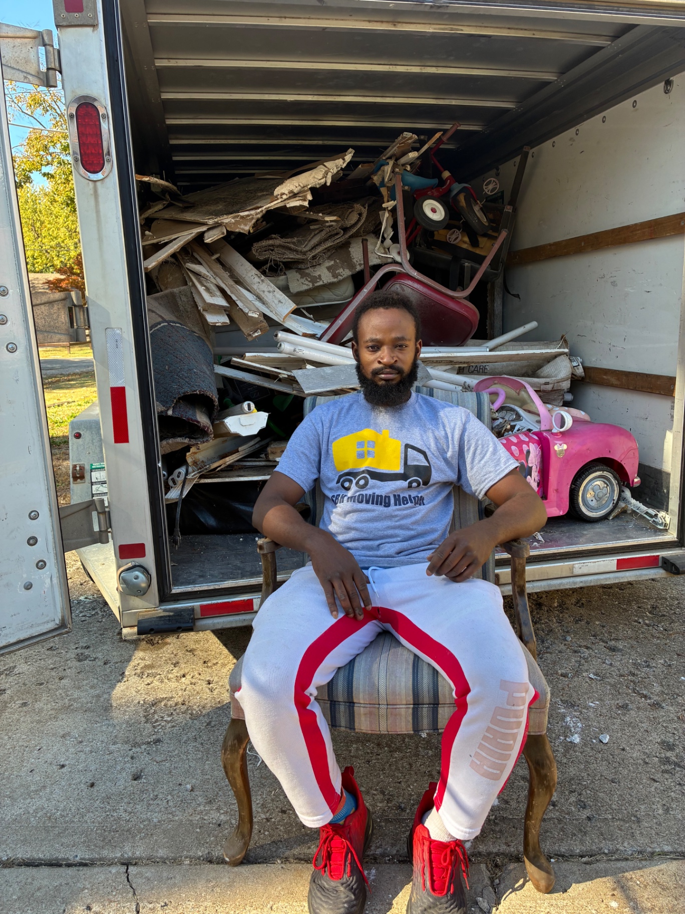 SBH crew member in front of a trailer full of removed junk and debris
