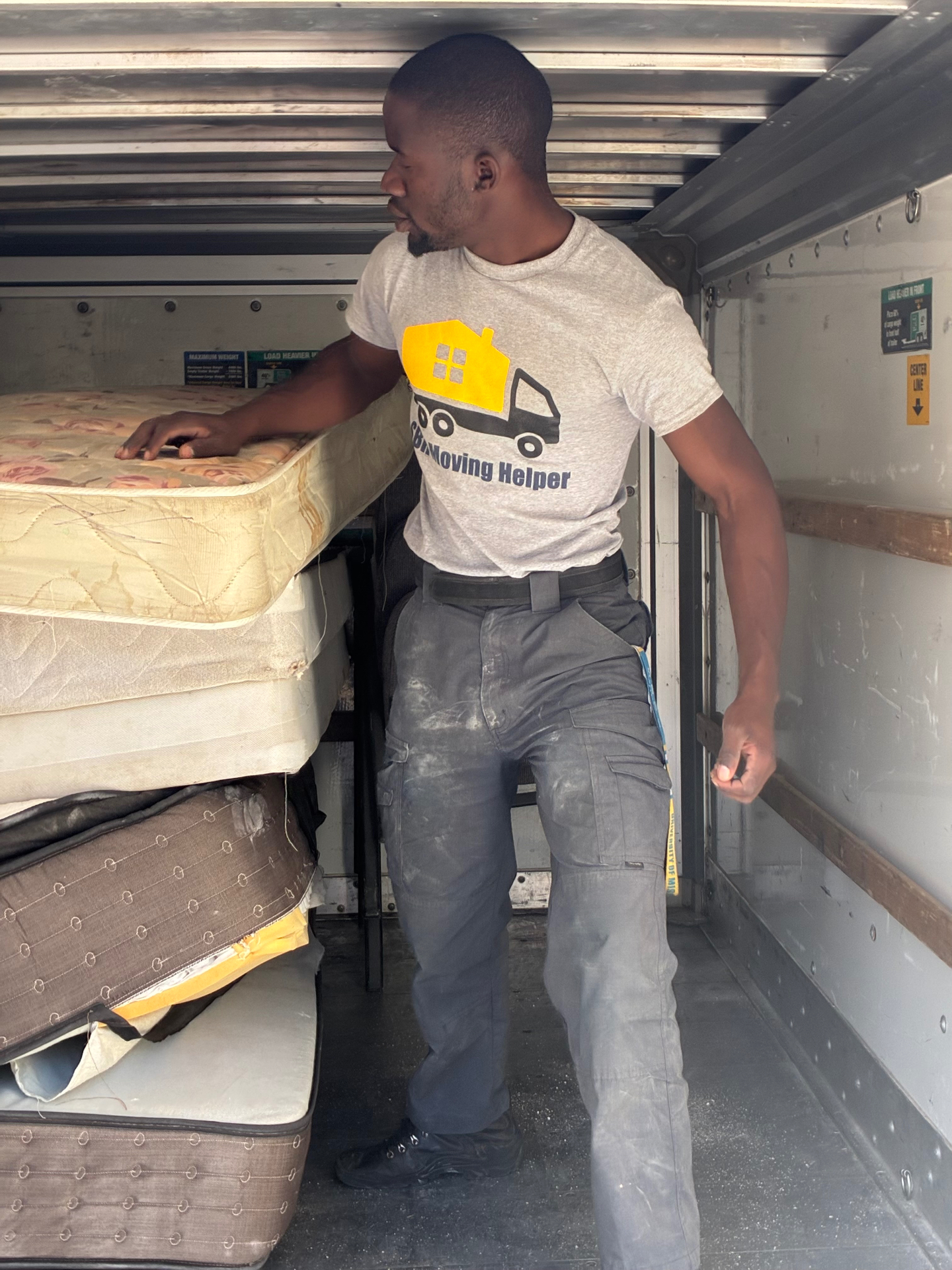 SBH mover removing old mattresses and box springs from a truck